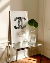 After Hover: Quote from fashion icon Coco Chanel - Logo in grey, black and white